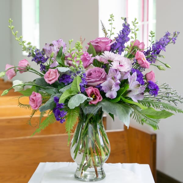 Pink and purple mixed bouquet in a clear glass vase