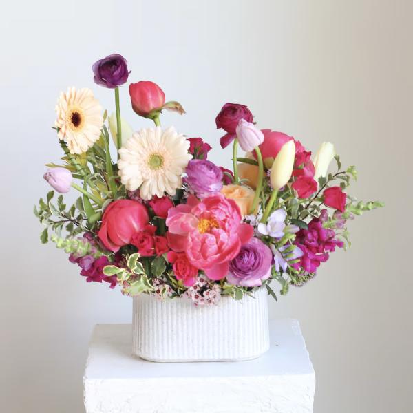Colorful mixed bouquet in a white ribbed vase