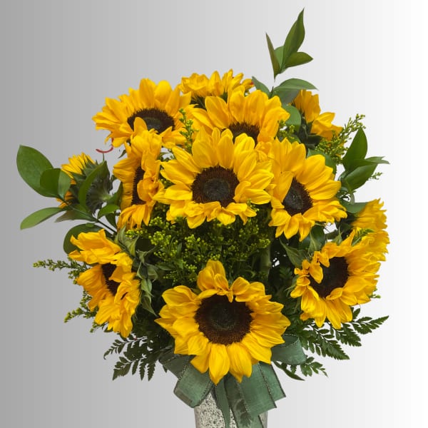 Bouquet of yellow sunflowers with green foliage and a ribbon-tied vase