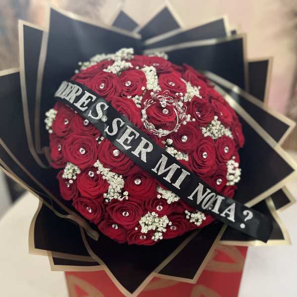 Red rose bouquet with white filler and a black ribbon banner
