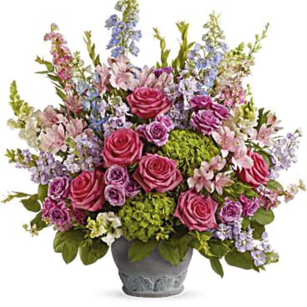 Pink and lavender mixed flower arrangement in a gray pot