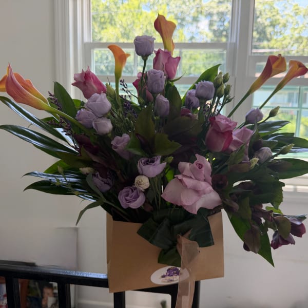 Bouquet of pink and lavender flowers in a kraft paper wrap