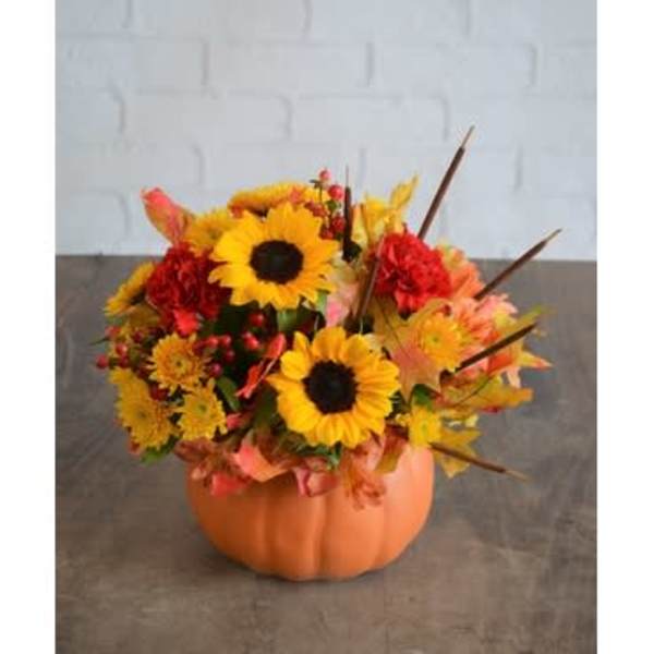 Sunflower arrangement in an orange pumpkin container
