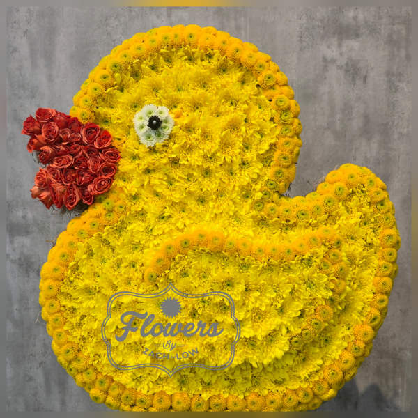 Duck-shaped floral arrangement made of yellow flowers with a red flower beak.