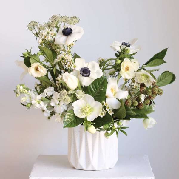 White floral arrangement in a textured white vase