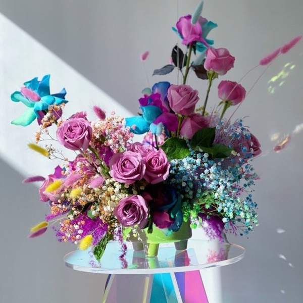 Bouquet of pink roses with bright blue and purple flowers