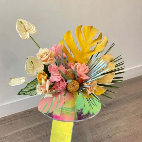 Tropical bouquet with pink roses and white anthuriums