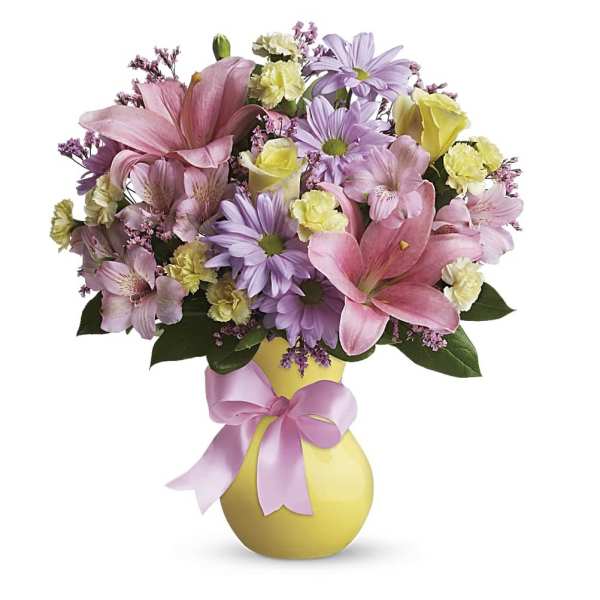 Pink and lavender mixed bouquet in a yellow vase with a pink ribbon