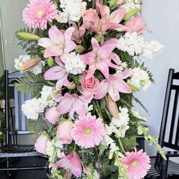 Tall pink and white floral standing arrangement on an easel