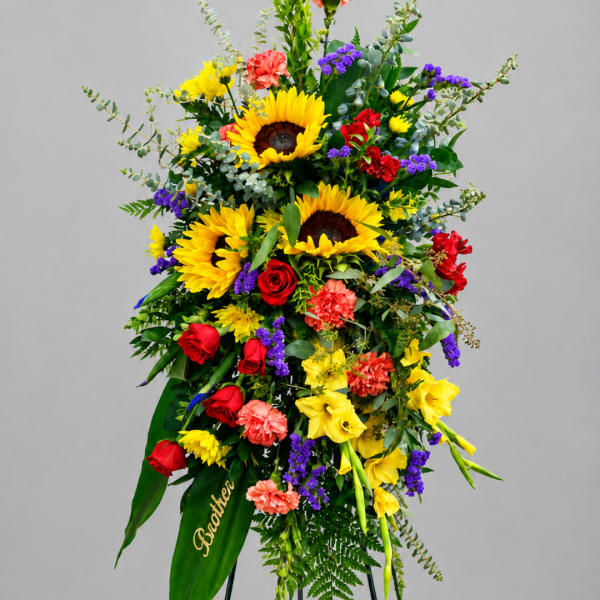 Tall floral standing spray with sunflowers, roses, and carnations