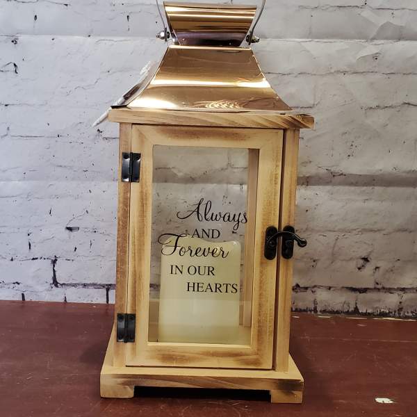 Wooden lantern with a candle and memorial text inside