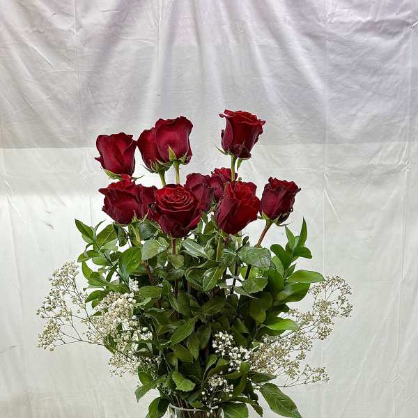 Tall vase arrangement of red roses with white baby's breath