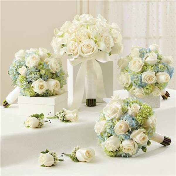 White rose bouquets with pale blue flowers and ribbon wraps