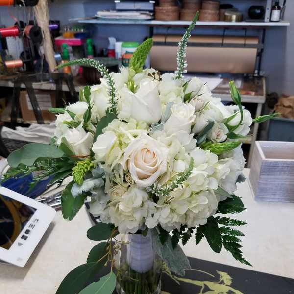 White rose and hydrangea bouquet in a clear glass vase
