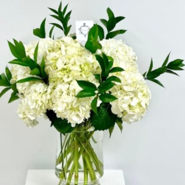 White hydrangea bouquet in a clear glass vase