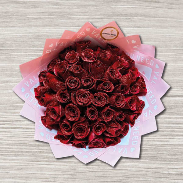 Bouquet of red roses wrapped in pink paper