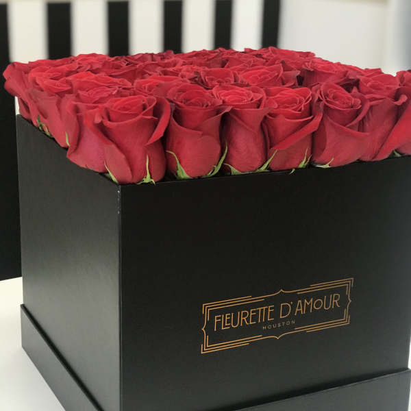 Red roses arranged in a black square box