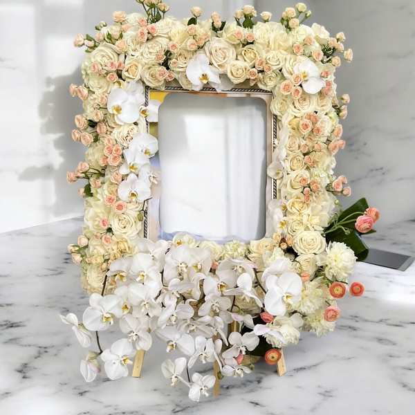 Floral frame covered in cream roses and white orchids