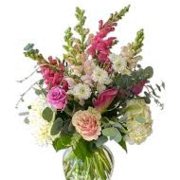 Mixed pink and white flowers in a clear glass vase