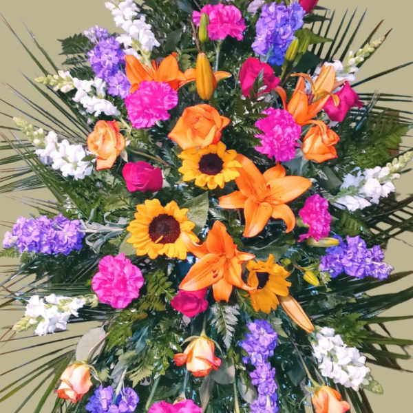 Large standing spray with orange lilies, roses, and purple flowers