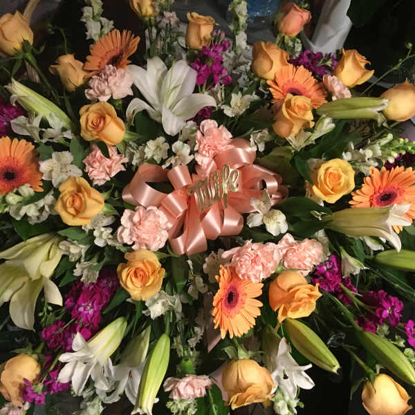 Large mixed bouquet with orange roses, lilies, gerbera daisies, and pink carnations