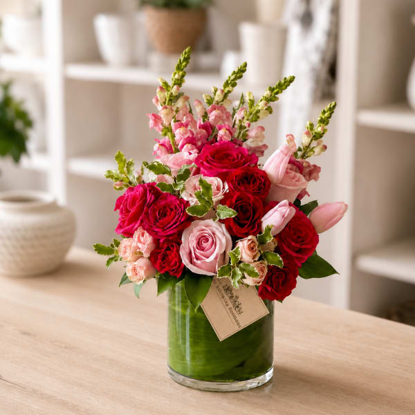 Pink and red rose arrangement in a glass vase