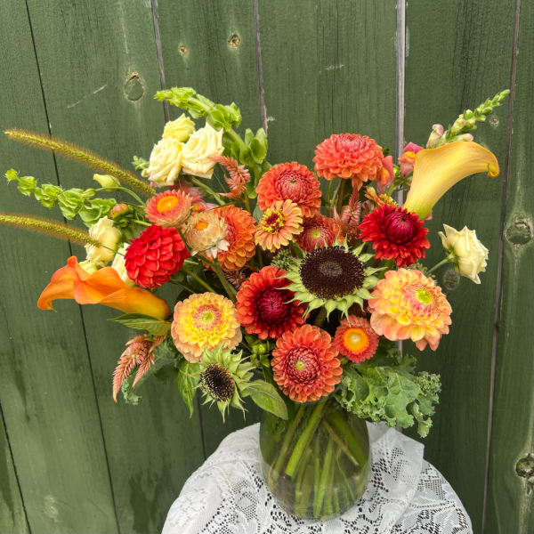 Mixed orange and yellow bouquet in a glass vase