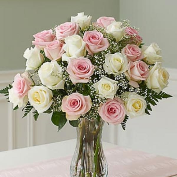 Bouquet of pink and white roses in a clear glass vase