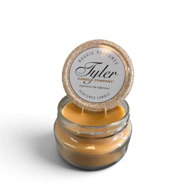 Jar candle with a round lid labeled Tyler Candle Company