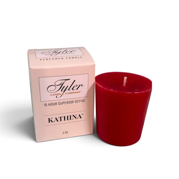 Red votive candle beside a pink candle box