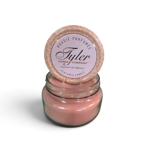 Pink scented candle in a glass jar with a matching lid
