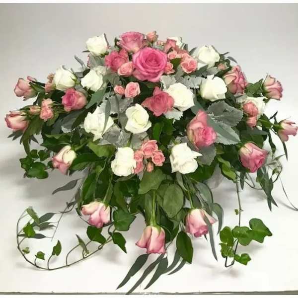 Pink and white rose bouquet with trailing greenery