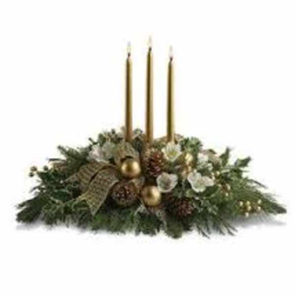 Holiday centerpiece with three gold candles and evergreen decor
