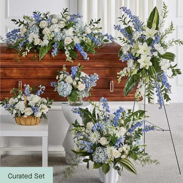 Blue and white floral funeral set with casket spray, standing spray, and vase arrangements