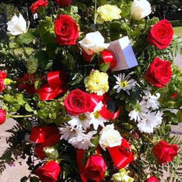 Standing floral spray with red and white roses and daisies