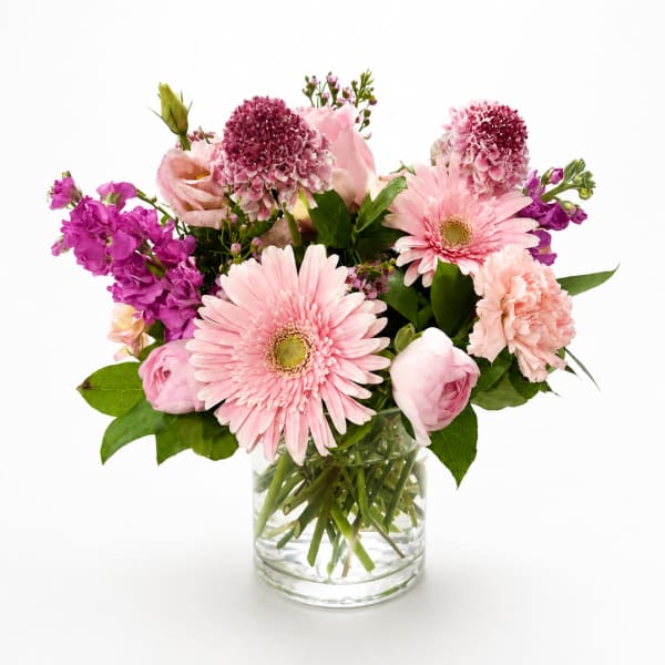 Pink mixed flower bouquet in a clear glass vase