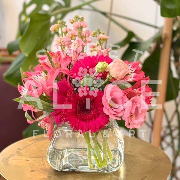 Pink mixed flower bouquet in a clear glass vase