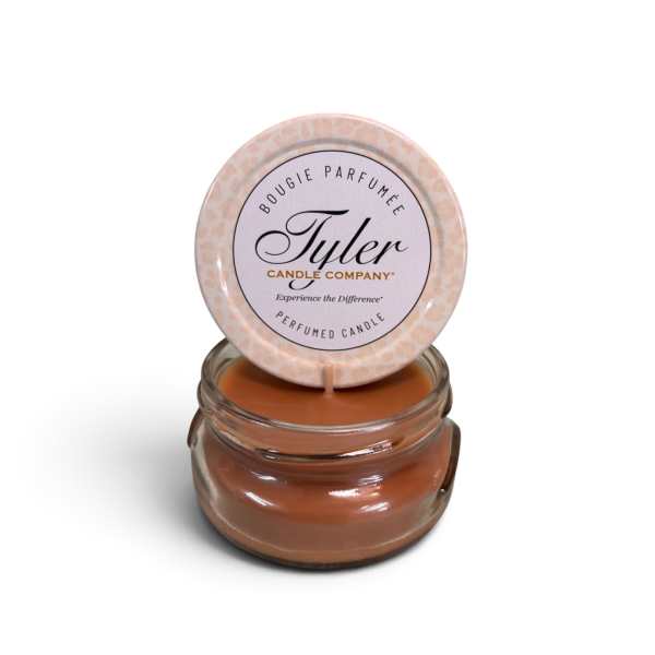 Small scented candle in a glass jar with a round lid label
