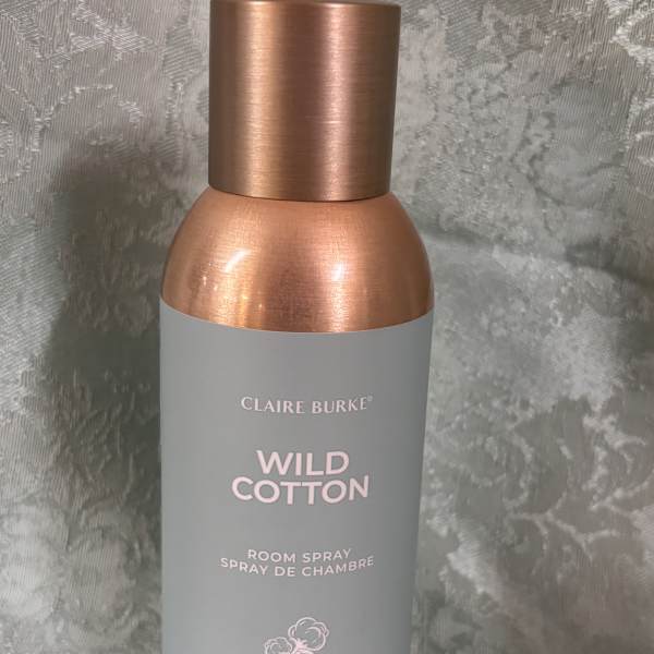 A Wild Cotton room spray bottle with a copper cap and gray label.