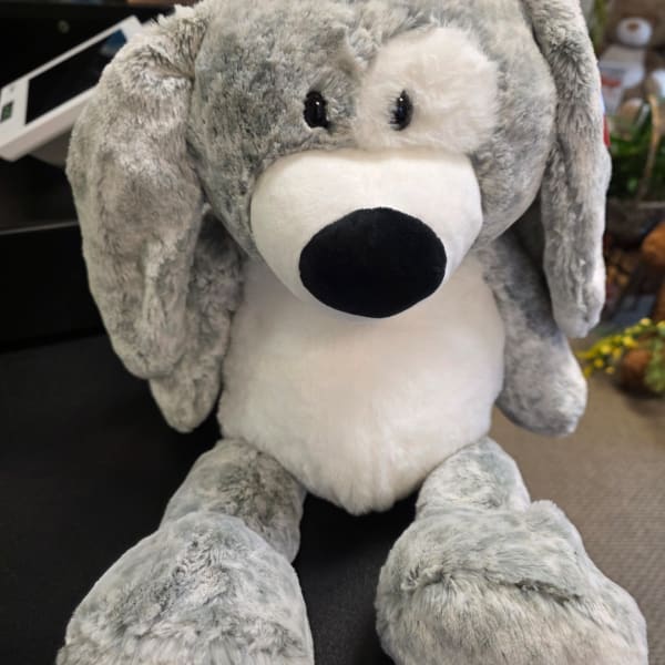 Gray and white plush dog toy with floppy ears and a black nose
