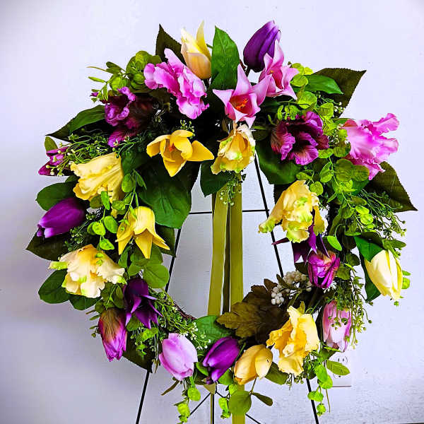 Heart-shaped floral wreath with pink, purple, and yellow blooms