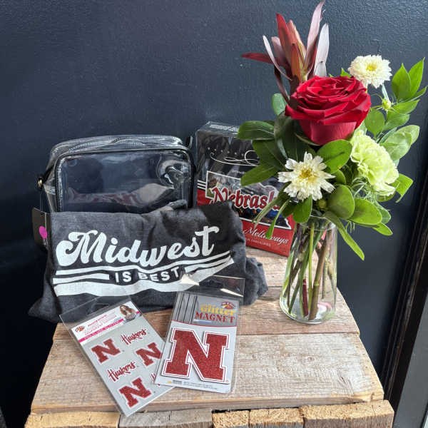 Gift set with a red rose arrangement in a glass vase and Nebraska-themed items