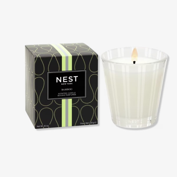 Scented candle in a glass holder beside its box