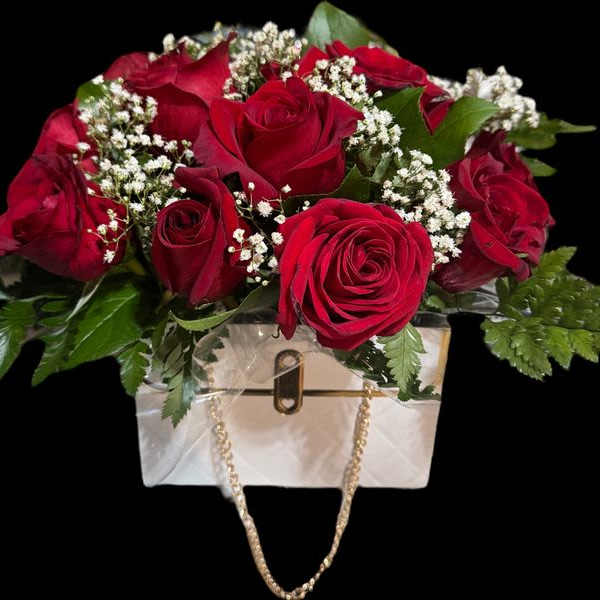 Red rose bouquet in a white handbag-shaped container