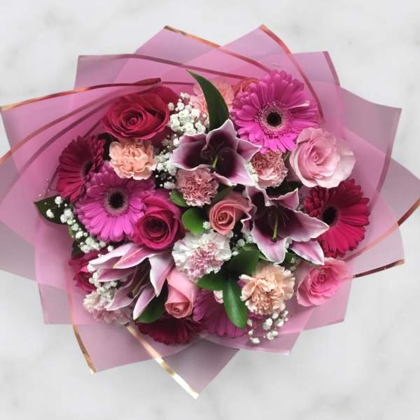 Pink bouquet with roses, gerbera daisies, lilies, and carnations