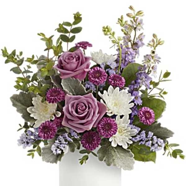 Lavender roses with purple and white mums in a white cylinder vase