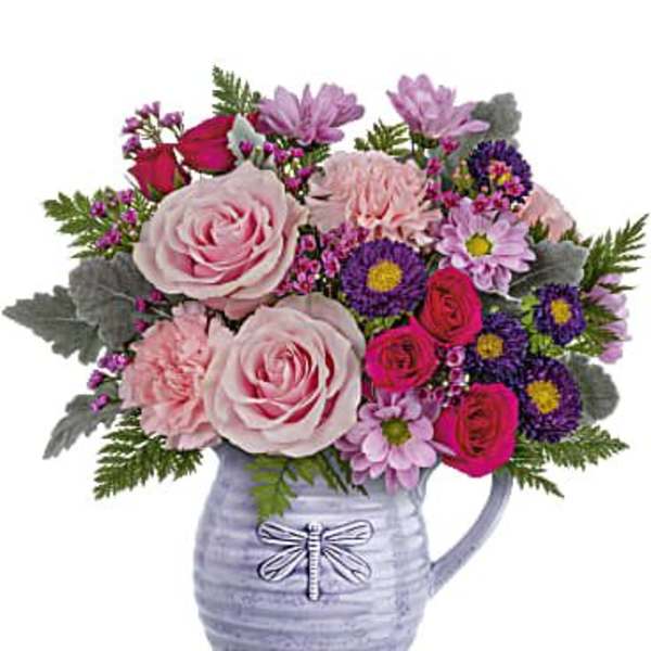 Mixed pink and purple bouquet in a lavender pitcher vase