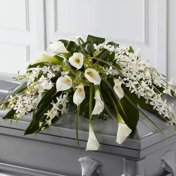 White floral casket spray with calla lilies and orchids