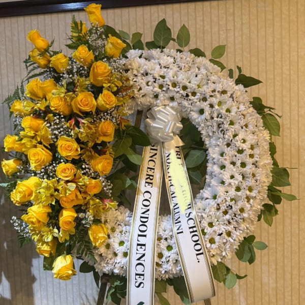 Yellow roses and white daisy wreath with condolence ribbons