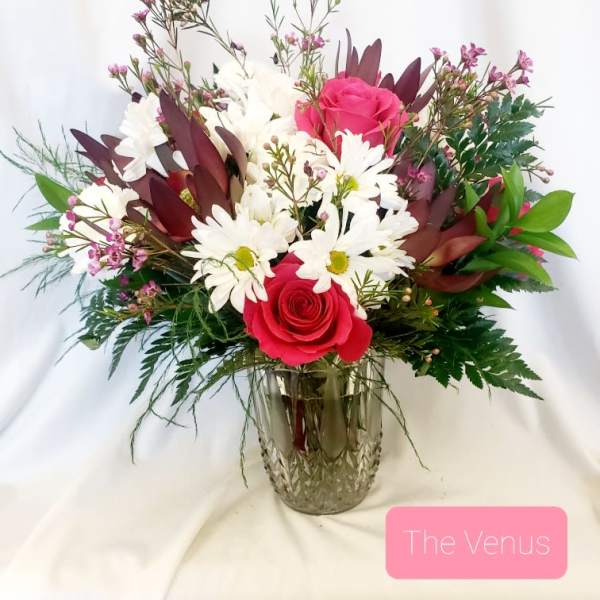 Bouquet of pink roses and white daisies in a glass vase